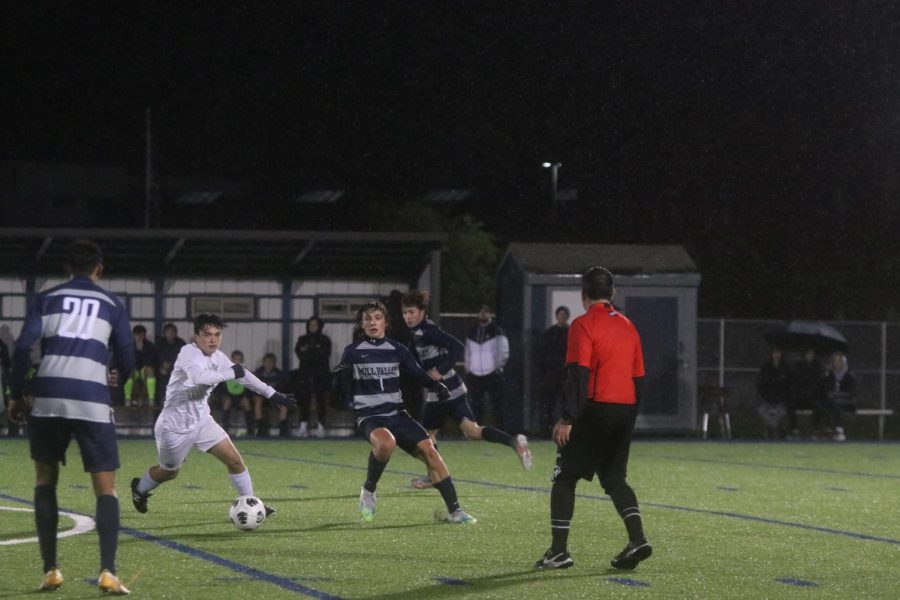 Running past his opponent, sophomore Kael Drummond runs in to steal the ball.