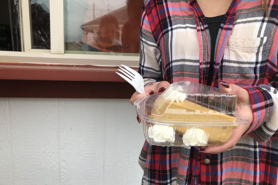 Sophomore Abigail Troilo holds the pumpkin cheesecake she purchased for $4.00.
