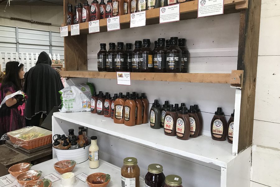Located in the giftshop, shelves containing various sauces are ready to be sold.