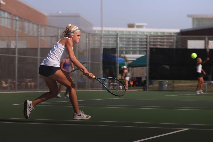 Lunging for the ball, junior Bri Coup works to win the point.