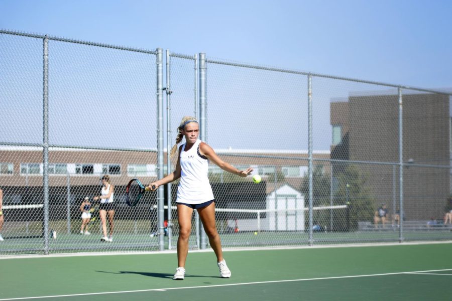 Ready to hit the ball, junior Bri Coup holds her racket. 