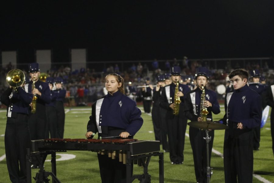 At the front of the field, juniors Kylie Wilson and Kaden Friend concentrate on the drum major