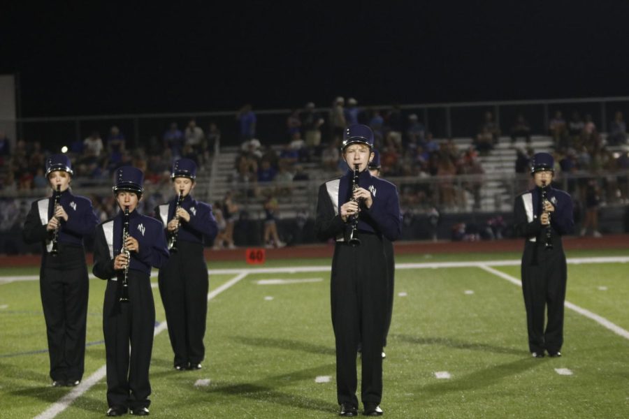 Standing in place, freshman Logan Koester plays his clarinet