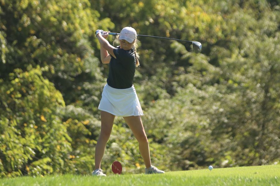 Eyes on the ball, senior Charley Strahm hits the ball out of the tee box.