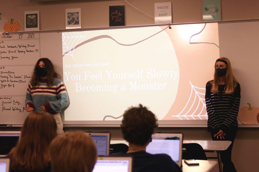 Presenting last weeks writing prompt, seniors Allison Rader and Ellie Basgall discuss how to share their stories with the club Wednesday, Oct. 13. 