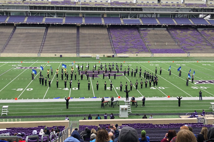 Pausing to show they have made their marks, the marching band performs for the K-State Band Festival judges. 