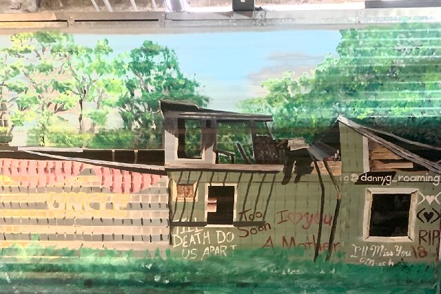 At the Attic, a painting of a worn down house is done by UMKC graduate, artist Danny Roaming. According to his Instagram (@dannyg_roaming), Roaming is a Hispanic-American who speaks out about the unjust treatment involving ICE through his art. 