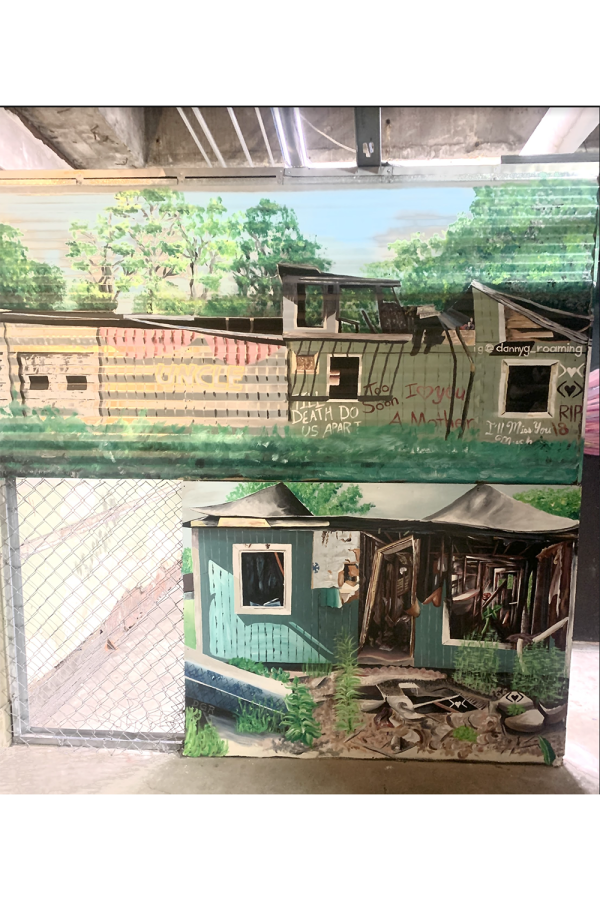At the Attic, a painting of a worn down house is done by UMKC graduate, artist Danny Roaming. According to his Instagram (@dannyg_roaming), Roaming is a Hispanic-American who speaks out about the unjust treatment involving ICE through his art. 