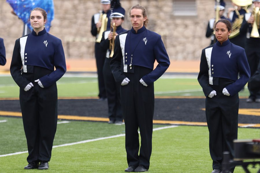 Drum majors senior Cameron Long, junior Gabby Delpleash and sophomore Addisyn White wait to be addressed by the announcer at the Emporia State Marching Festival Wednesday, Oct. 6. 