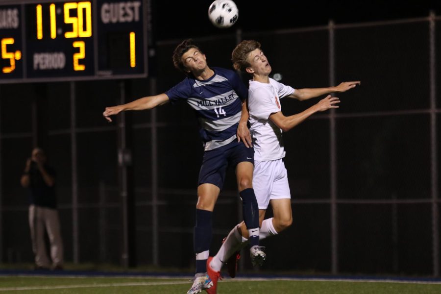 Jumping up, senior Brooks Scheelk goes in for a header.
