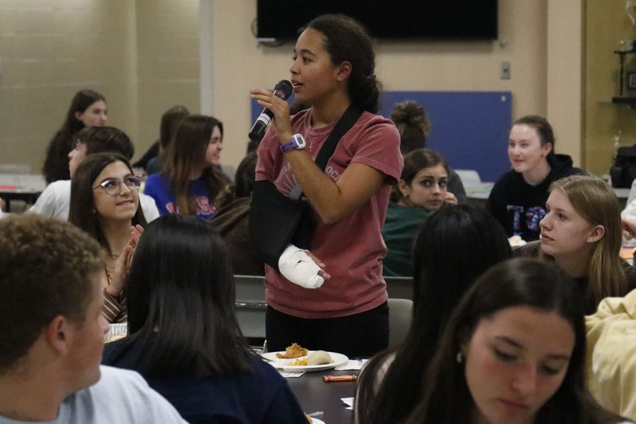 Speaking to the crowd, junior Gabby Delpleash announces that paper day is tomorrow for the newspaper. 
