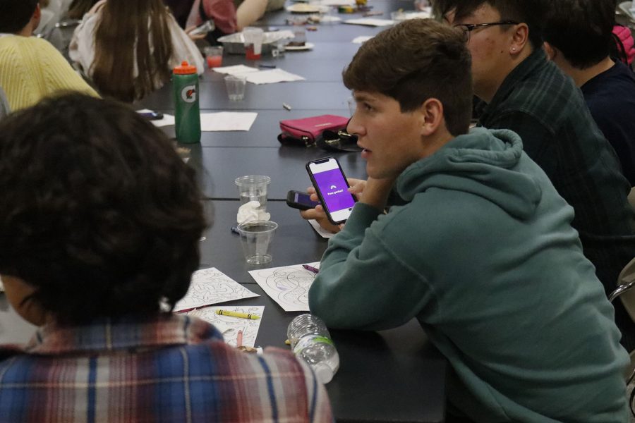 Eyes intent on the screen, senior Yahael Anderson competes in the Kahoot game. 