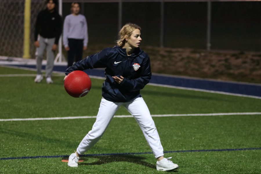 As she winds back her arm, junior Taylor Modrcin pitches the kickball. 