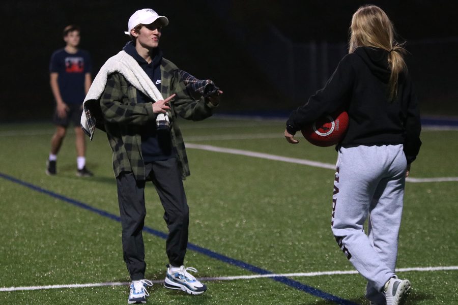 Junior Avery Blubaugh explains the rules to freshmen while junior Sonny Pentola refs the game. 