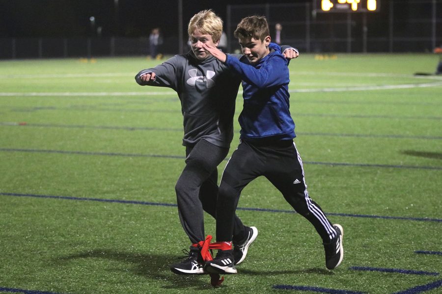 Arms wrapped around each other, middle schoolers Ben Muller and Jonathan Brazil try to get the fastest race time. 