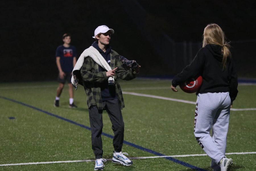 Junior Avery Blubaugh explains the rules to freshmen while junior Sonny Pentola refs the game.