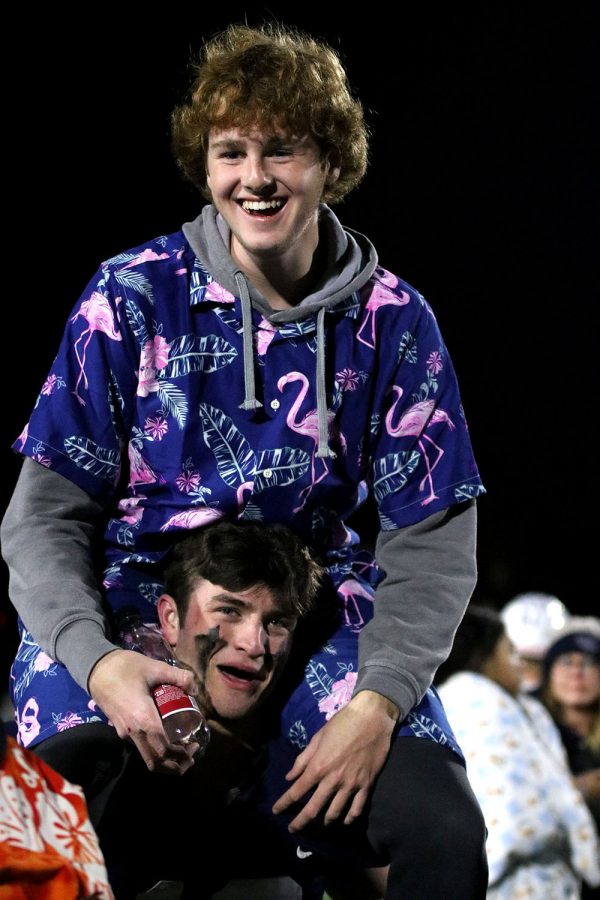 With senior Henry Coulson on his shoulders, senior linebacker Payton Douglas carries him around the field.