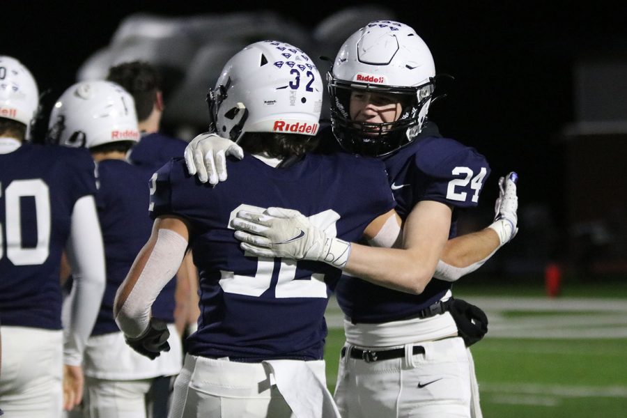 To celebrate their substate championship, junior defensive back Hudson Ivey hugs senior defensive back Jay Ybarra after shaking hands with the opposing team to end the game.