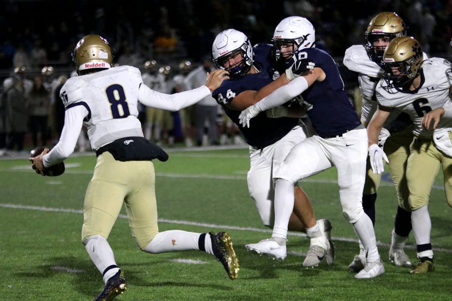 Rushing the quarterback, senior defensive back Aidan Shaffer and junior linebacker Broc Worcester run towards their opponent.