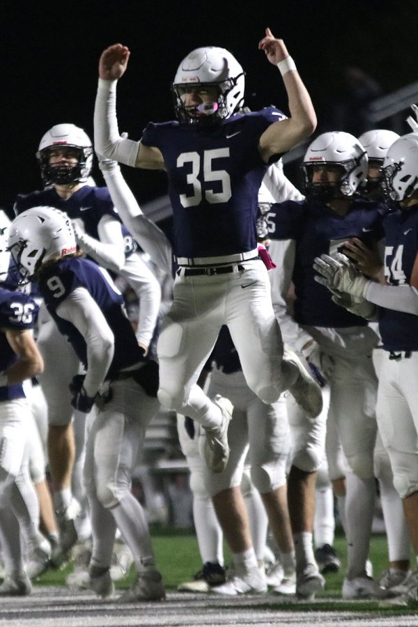 After scoring a touchdown, sophomore running back Tristan Baker jumps up into the air to celebrate with his teammates.