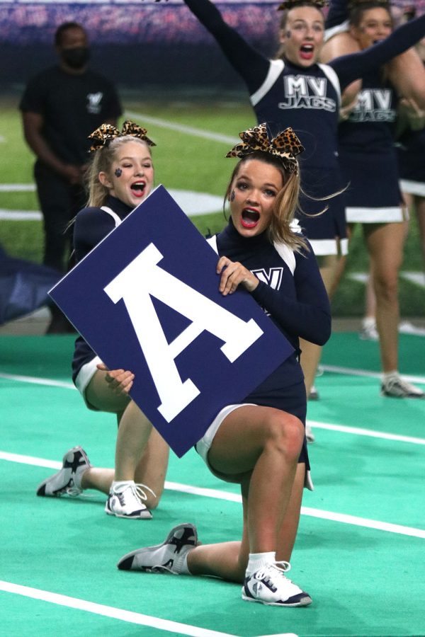 Holding the letter “A”, senior Rheagan Handy shouts her chant to the audience during their performance.