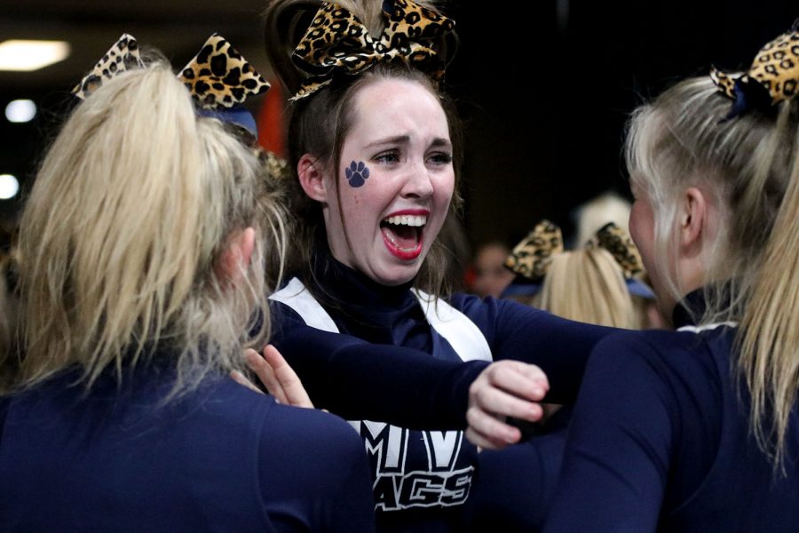 Walking back to practice their final routine, junior Kate Kline goes to hug senior Audra Finley after being announced finalists.