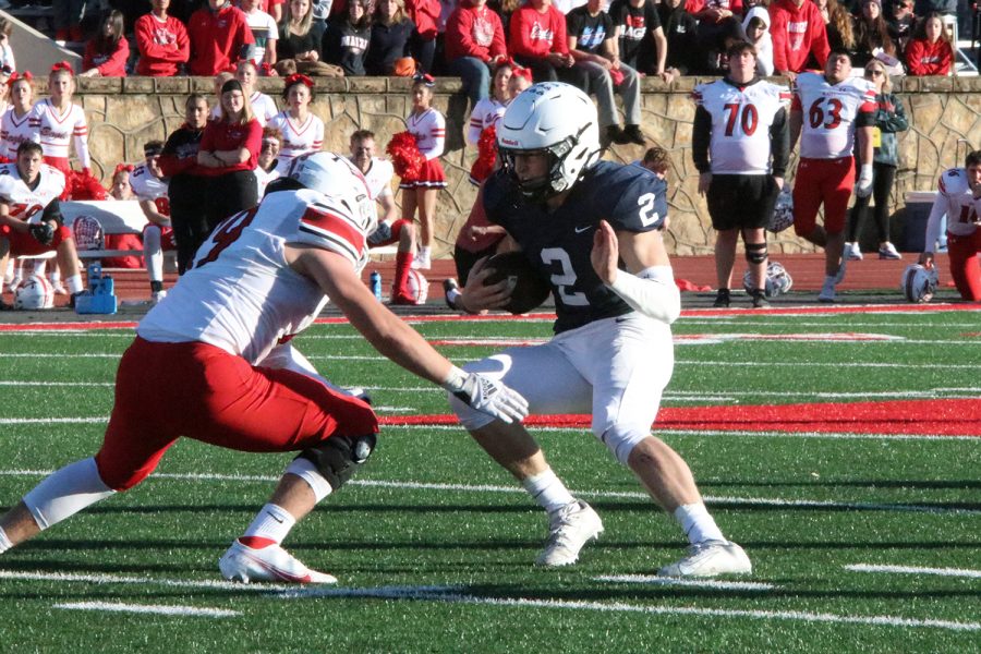 Stopped by his opponent, junior quarterback Hayden Jay switches up his running path to advance further down the field. 