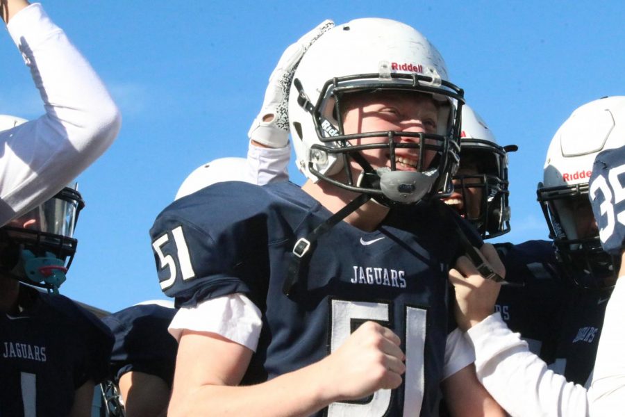 On the sidelines, freshman defensive lineman Conner Wood cheers on his teammates. 