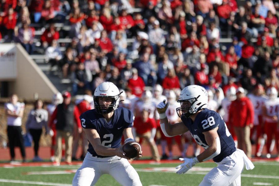 Junior Hayden Jay hands the ball off to senior Reice Kennedy in order to gain yards.