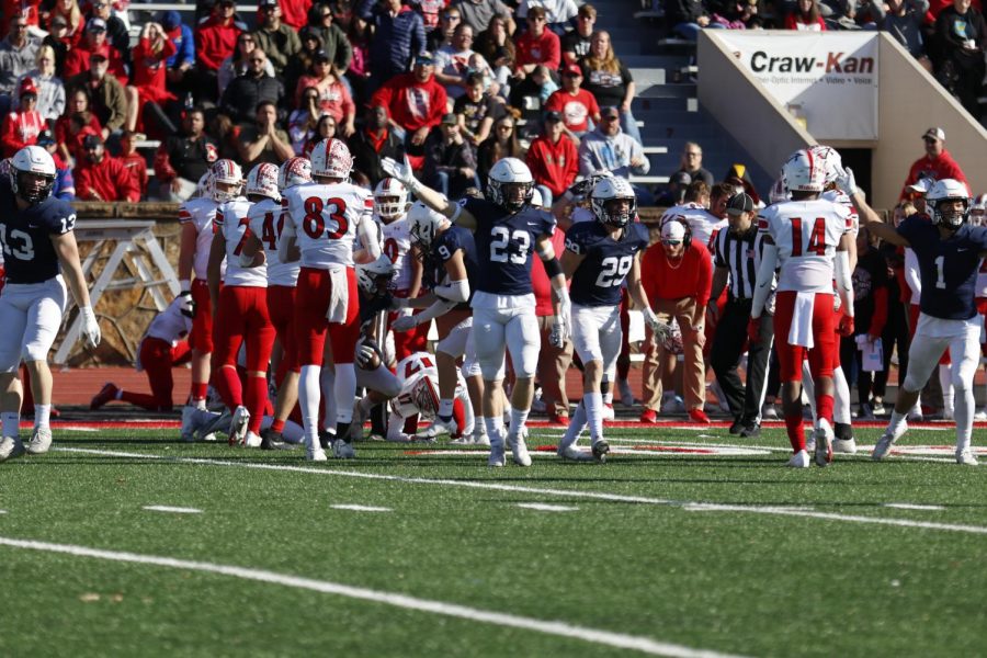 Walking away from the tackle, junior Holden Zigmant holds his arm up showing that there was a turnover.