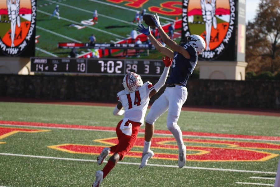 Jumping above the opponent, senior Kendrick Jones reaches to catch the ball.  