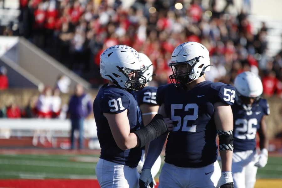 After a defensive play, senior Cody Moore gives junior Grant Rutkowski some motivation.