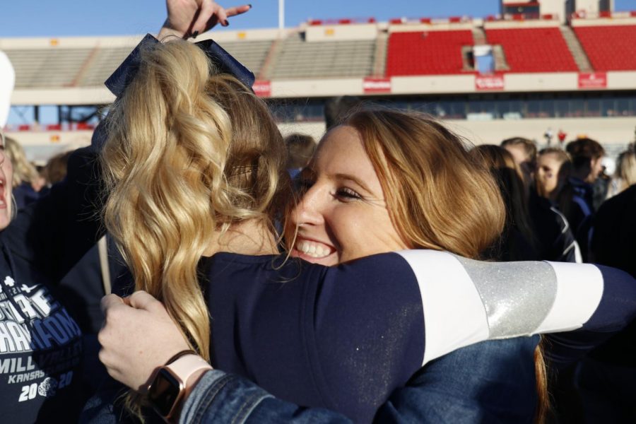 Celebrating the win, junior Macee Moore hugs sophomore Olivia Moore.