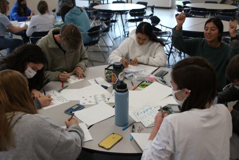 Making cards, students in NHS gather in the senior cafe Friday, Nov. 19 to make holiday cards for soldiers overseas in order to earn service hours.