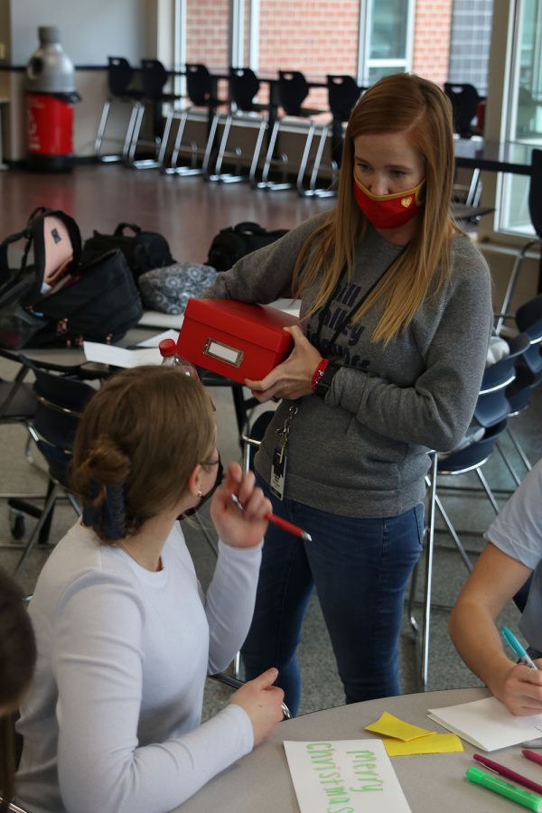 Supervising, NHS sponsor Cathy Stevens makes sure everything is in order for the military cardmaking session Friday, Nov. 19.