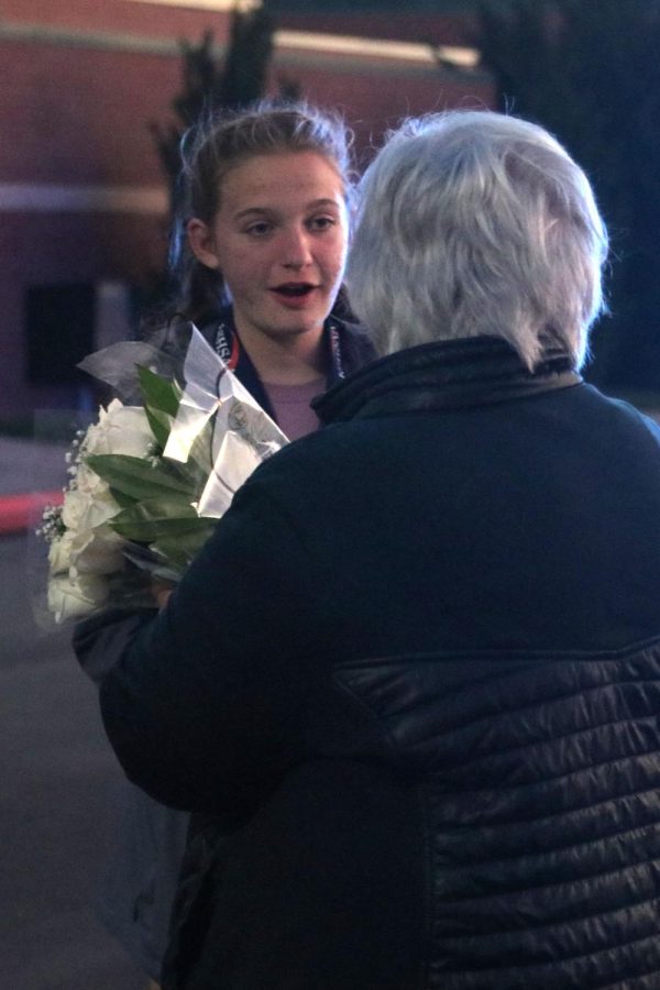 Freshman Meg McAfee receives a bouquet of flowers from her grandma in congratulation for her win. 