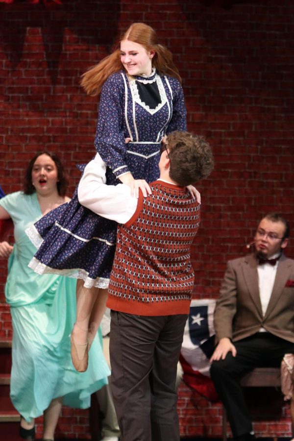 With a smile on her face, sophomore Ashley Makalous is lifted into the air.