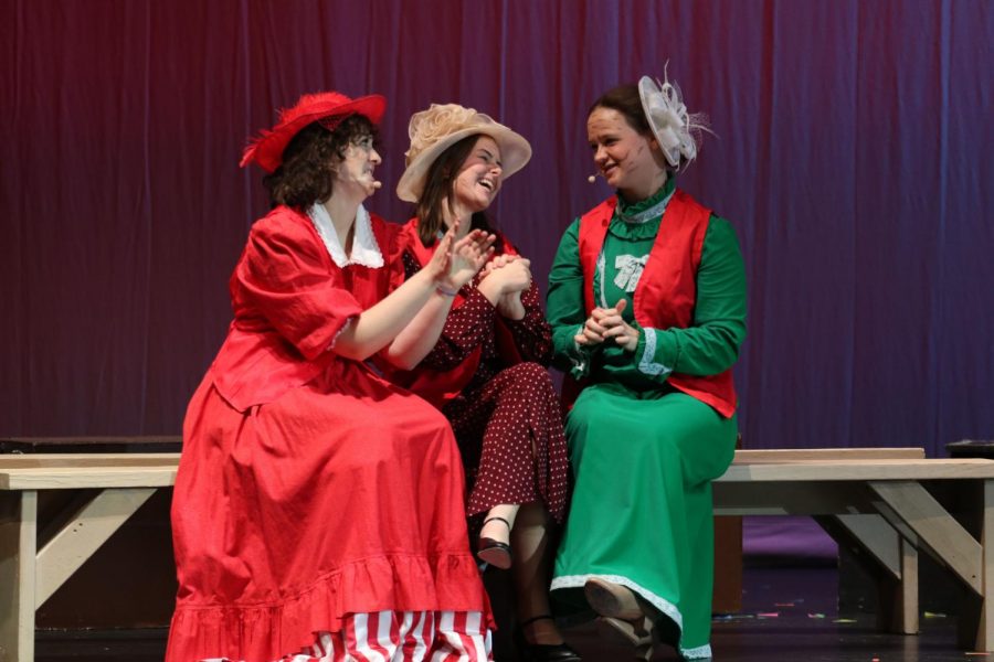 Sitting together on the bench, sophomore Riley Martin, senior Katelyn Kurvoski and junior Cassie Frias laugh together. 