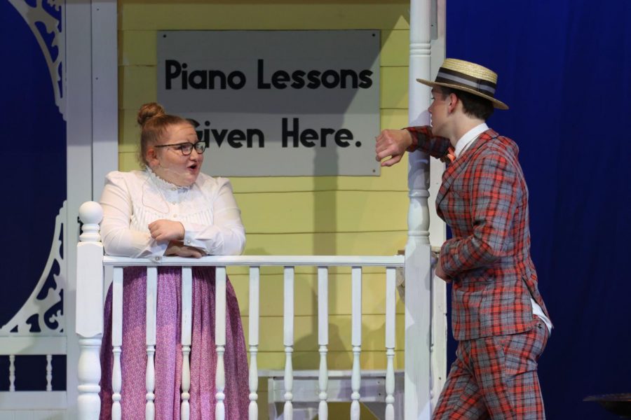 Arm leaned against the porch, junior Finn Campbell converses with senior Hayley O’Keefe. 