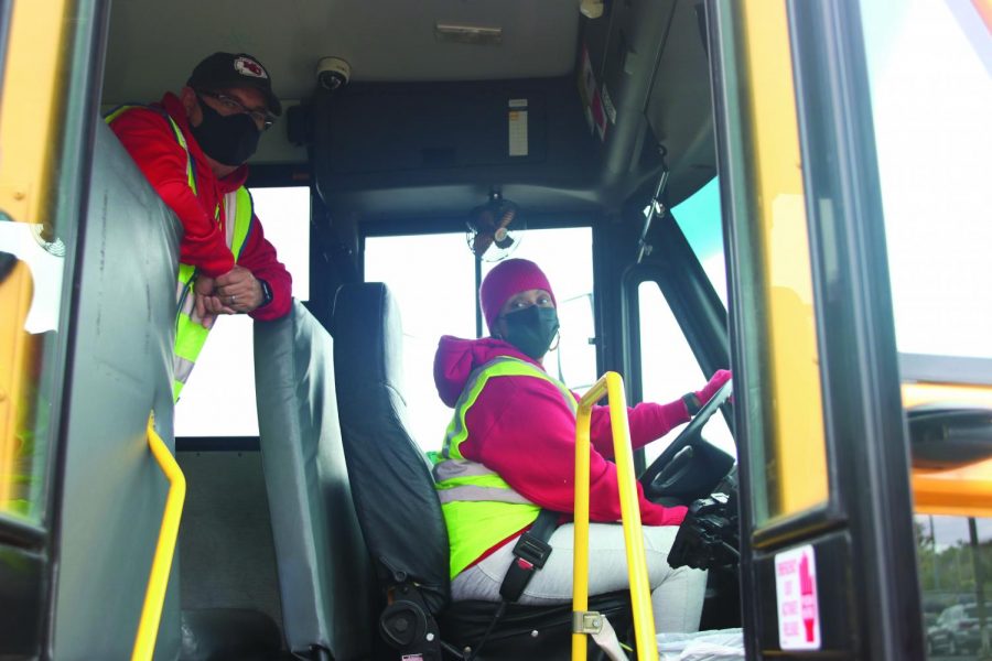 Bus drivers Glen White and Veronica Hollinger wait for kids to load the bus on Friday, Oct. 29. White and Hollinger are two of several bus drivers who have been effected by lack of staffing this year.