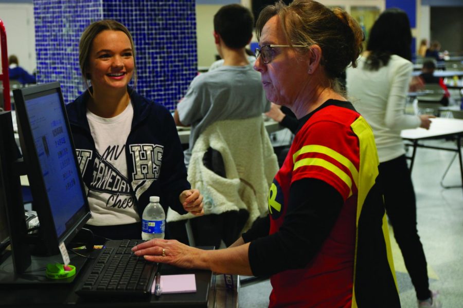 Senior Rheagan Handy going through the lunch line visiting with nutrition assistant Pam King on Friday, October 29th.