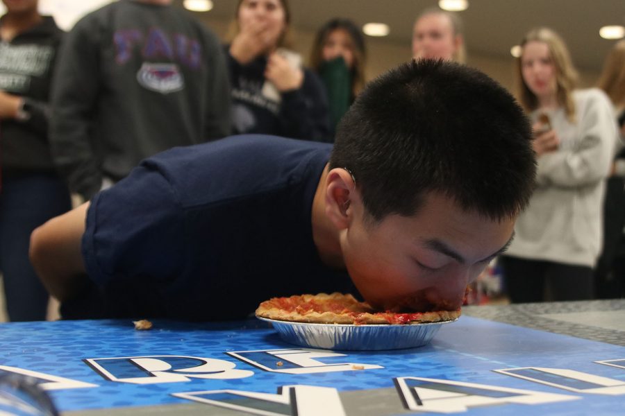 With his hands behind his back, freshman Ammon Hill participates in the pie-eating contest.