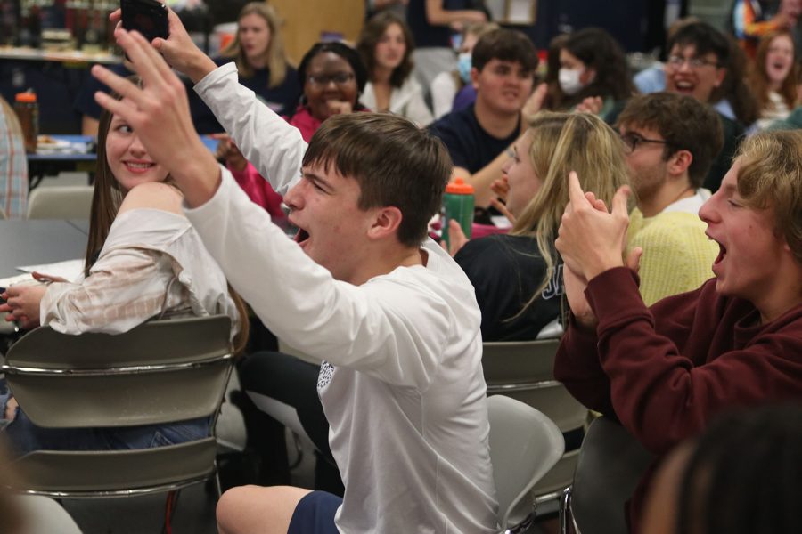 After winning the Kahoot, junior Bryce Martin throws his hands up in the air to celebrate.