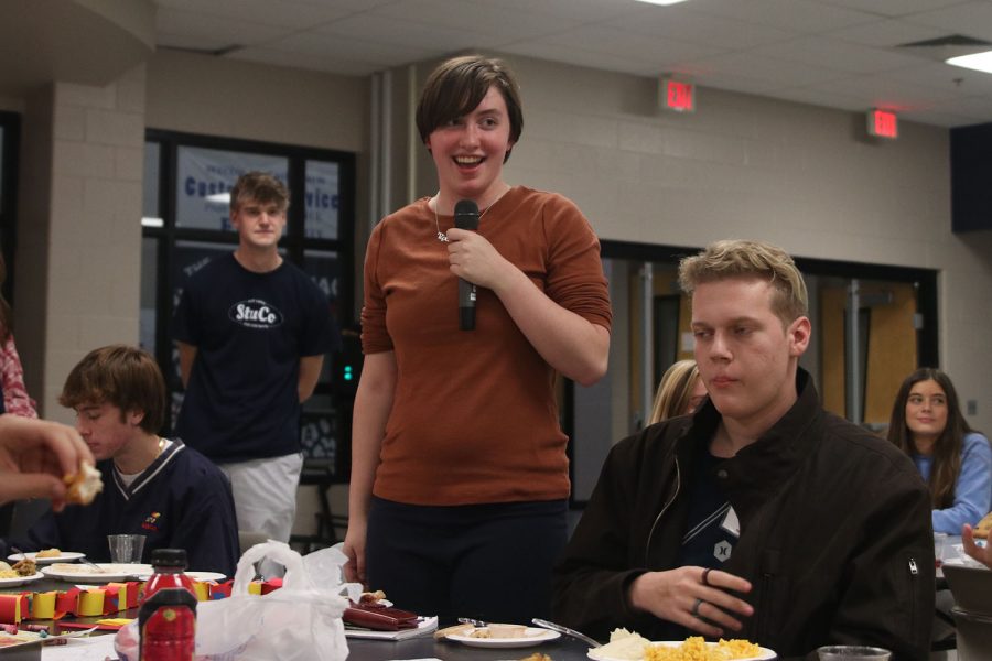 Holding the microphone, senior Julianne Long shares about the new Dungeons and Dragons school club.