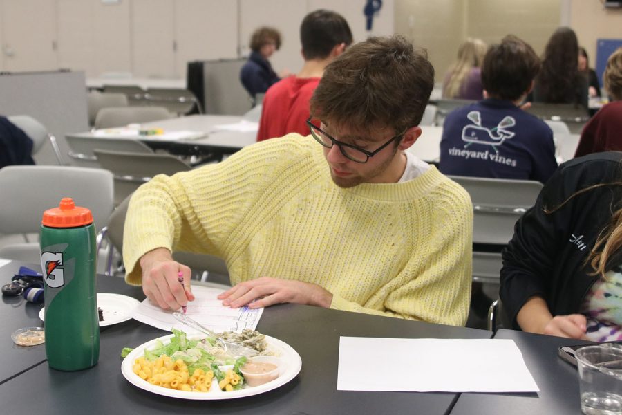 Crayon in hand, senior Nic Botkin colors a Thanksgiving-themed sheet.