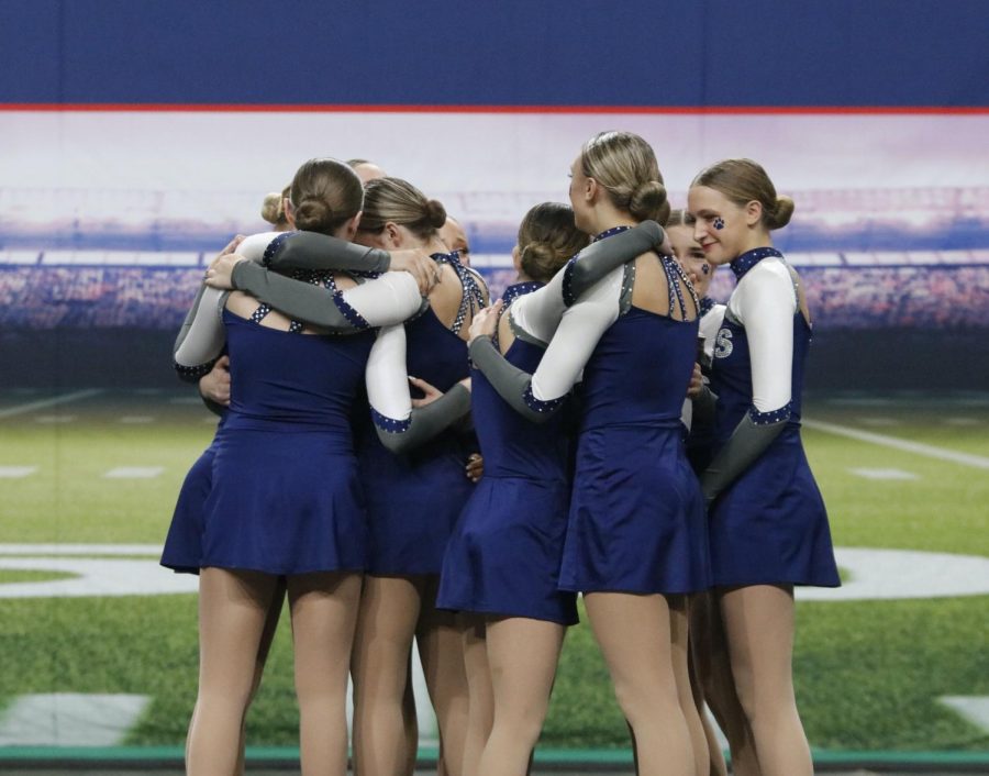 After winning first at state for the second consecutive year, the silver stars celebrate and hug each other after their hard work.
