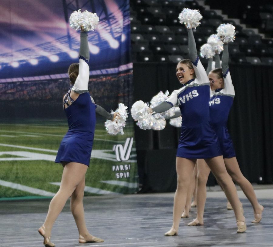 Facing each other, senior Anna Brazil and sophomore Halle Wampler smile during routine.