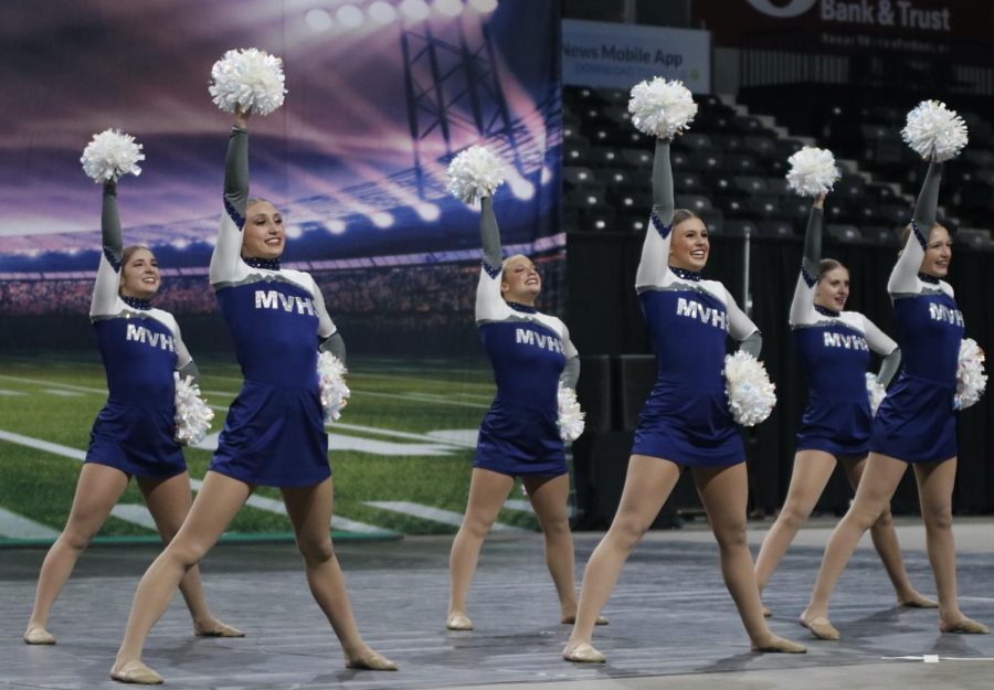 With their right hands in the air and left hand on their hips, the Silver Stars complete their final game day performance. 