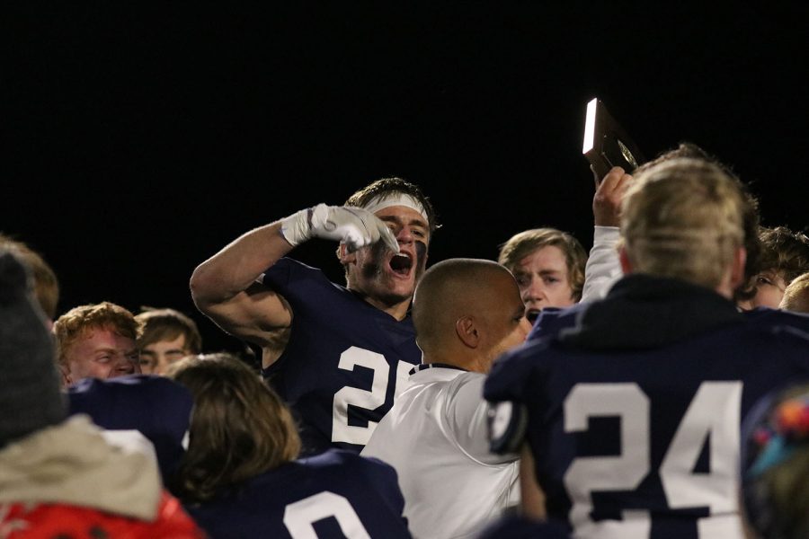 After head coach Joel Applebee concludes the huddle, senior Jason Smith celebrates. 