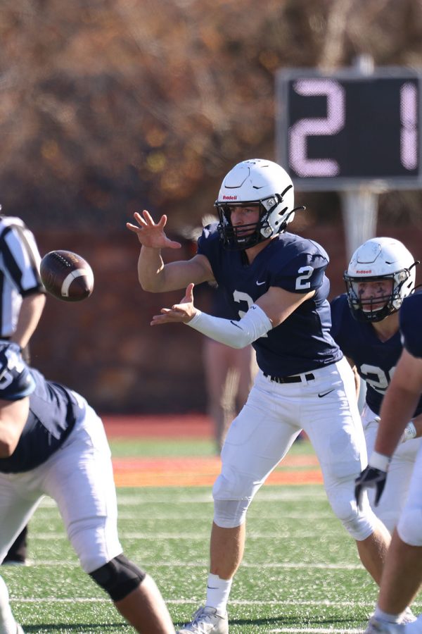 After the snap, junior quarterback Hayden Jay catches the ball. 